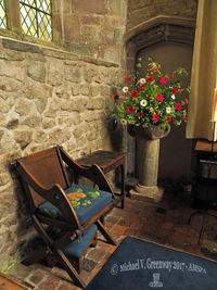 Flowers in vase on chair