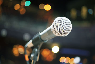 Close-up of microphone in illuminated lights