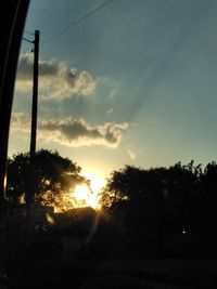 Silhouette trees against sky during sunset