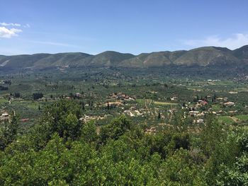 Scenic view of green landscape against sky