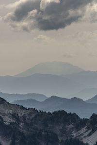 Mount saint helens viewed from mount rainier showing foggy valleys and peaks.