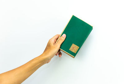 Hand holding paper against white background