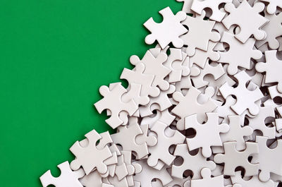 High angle view of jigsaw puzzle on green background