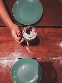 High angle view of hand holding cake