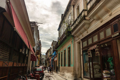 Narrow street amidst buildings in city