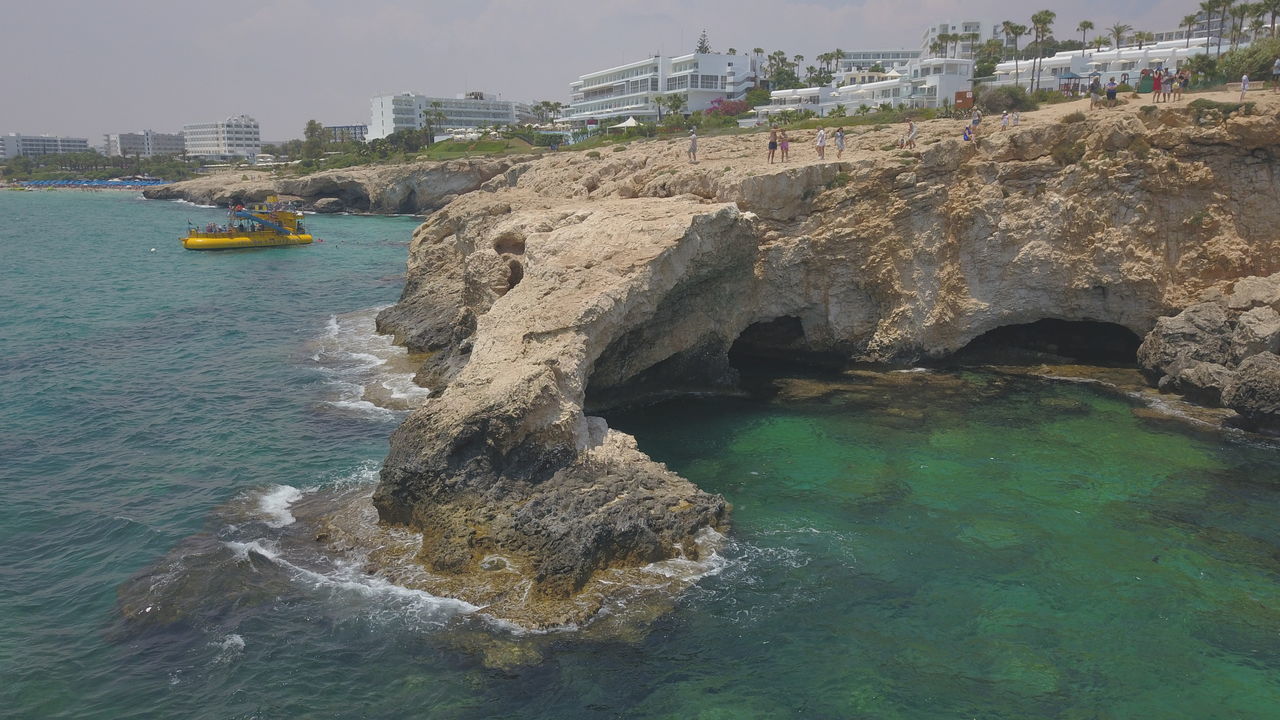 ROCK FORMATIONS IN SEA AGAINST SKY