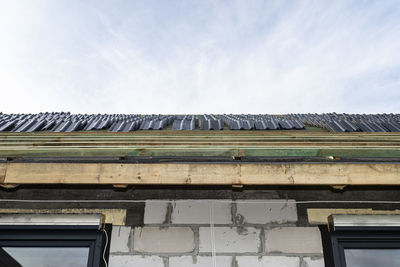 Roof ceramic tile arranged in packets on the roof on roof battens. laying tiles on a boarded roof.