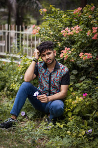 Portrait of young man sitting outdoors