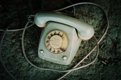 Close-up high angle view of an abandoned telephone