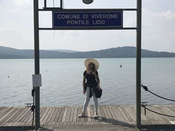 Full length of woman standing by sea against sky