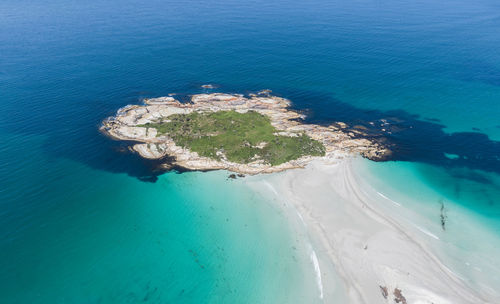 Aerial drone view of diamond island, cod rock, near the beach village bicheno, tasmania, australia.