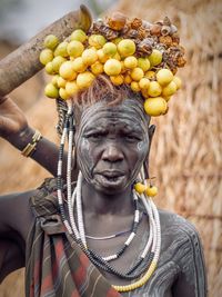 Portrait of man holding fruits