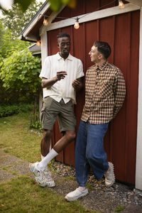 Full length portrait of senior couple standing on field