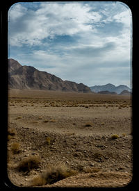 Scenic view of mountains against cloudy sky