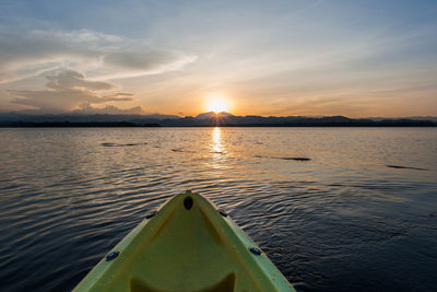 Boat on lake during sunset