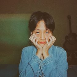 Portrait of young woman covering face