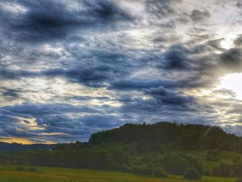 Scenic view of land against sky during sunset