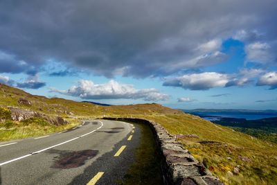 Road passing through landscape against sky