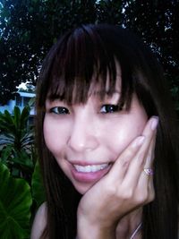 Close-up portrait of a smiling young woman