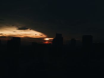 Illuminated cityscape against sky at night