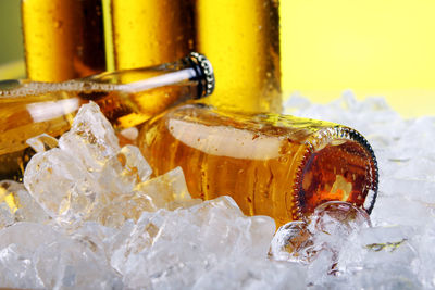 Close-up of yellow glass bottle on table