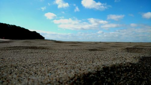 Close-up of sand on beach against sky