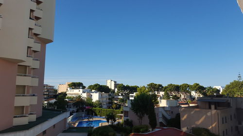 Buildings in town against blue sky