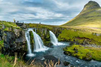 Scenic view of waterfall against sky