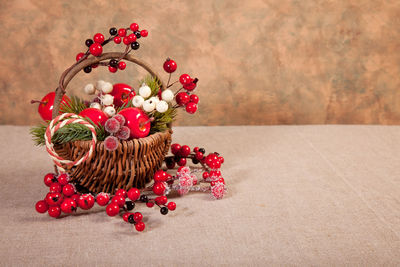 Close-up of christmas decoration on table against wall