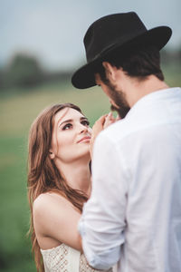 Young couple standing on field