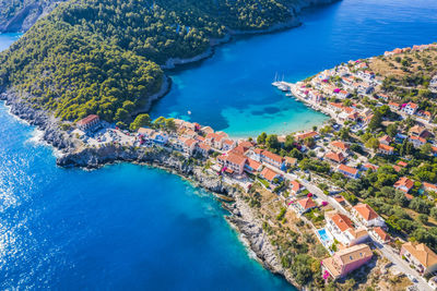 Assos picturesque fishing village from above, kefalonia, greece. aerial drone view.