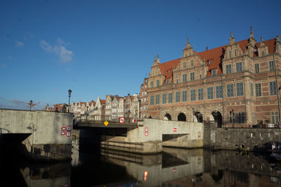 Bridge in city against sky