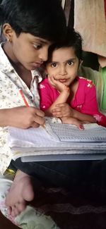 Portrait of a smiling girl sitting outdoors