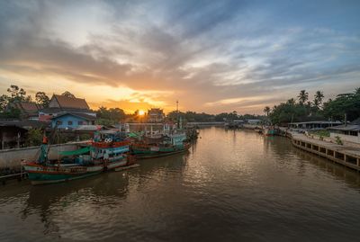 Boats in river at sunset