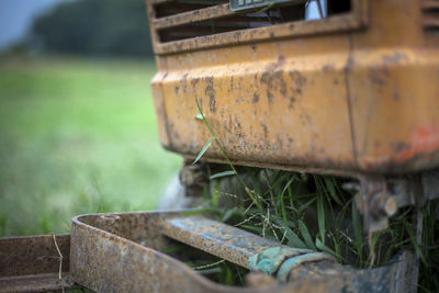 Close-up of rusty metal on field