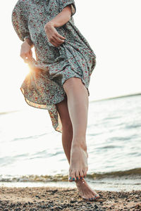 Low section of woman at beach