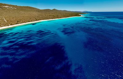 Scenic view of sea against blue sky