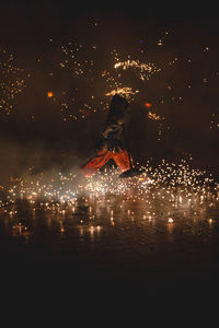 Person walking on fireworks at night
