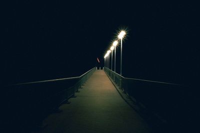 Illuminated street lights on footpath at night