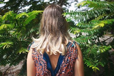 Rear view of woman with palm tree