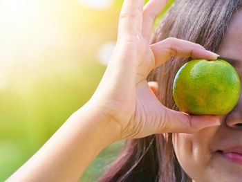 Midsection of woman holding fruit