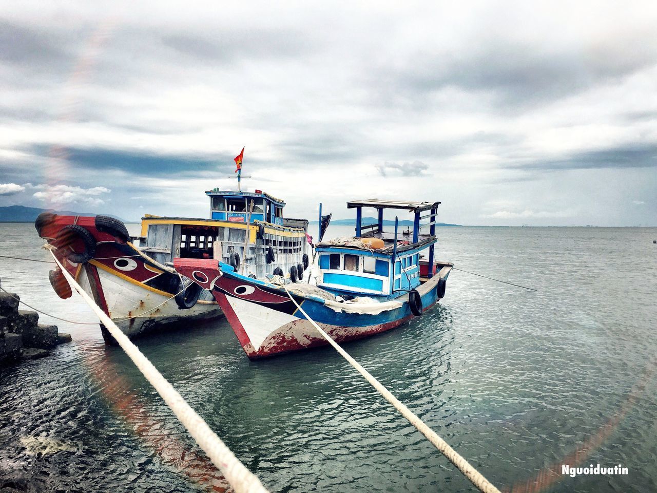 SHIP MOORED AT SEA AGAINST SKY