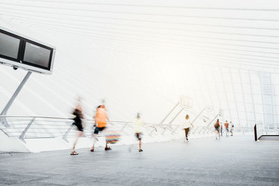 People walking in front of building