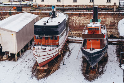 High angle view of boats moored on snow covered field