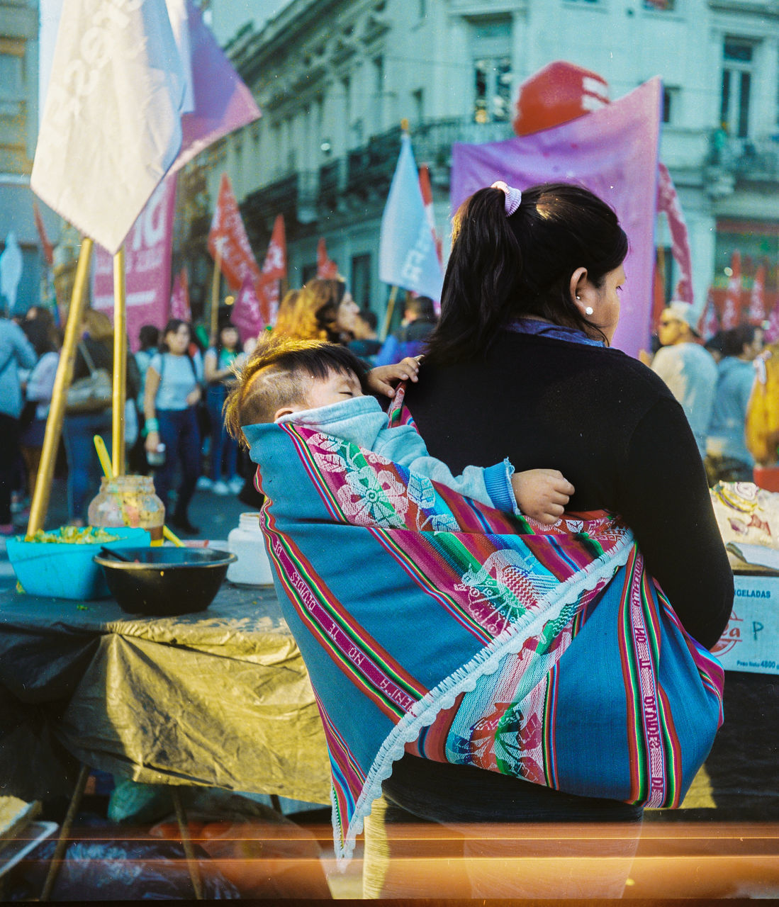 women, rear view, real people, lifestyles, adult, people, sitting, clothing, traditional clothing, leisure activity, incidental people, full length, focus on foreground, city, architecture, day, retail, hairstyle