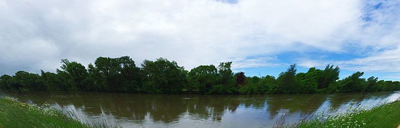 Scenic view of lake against cloudy sky