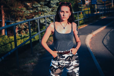 Young woman standing on road 