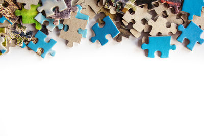 High angle view of multi colored pencils over white background