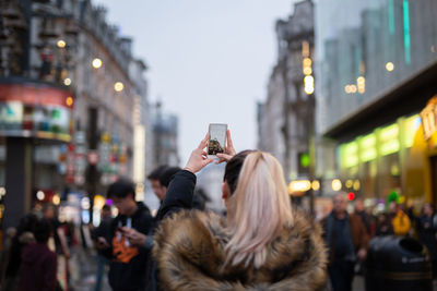 Rear view of woman photographing