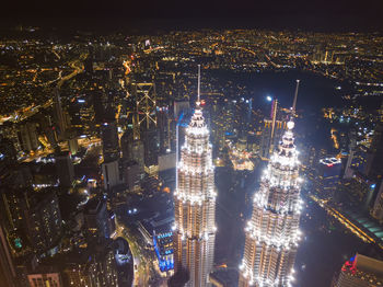 High angle view of city lit up at night